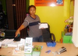 Kwandao Wingwon points to the spot where her computer once was, before long shark enforcers took it for lack of payment.